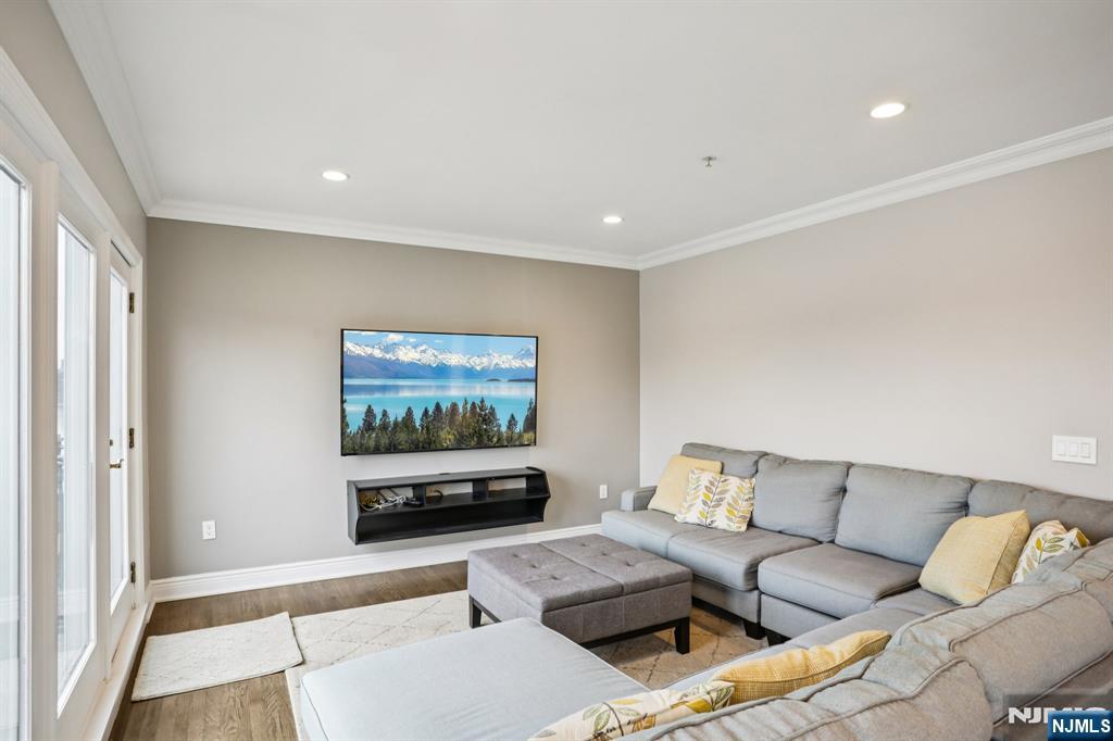 343 The Promenade, Unit 343 Edgewater, NJ 07020 - Photo 3 of 38 a living room with furniture and a flat screen tv