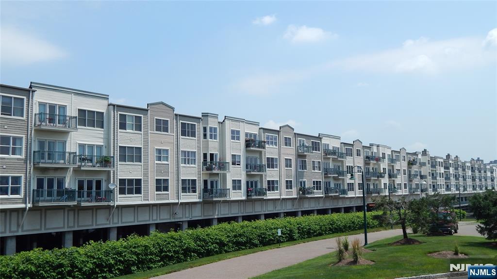 343 The Promenade, Unit 343 Edgewater, NJ 07020 - Photo 37 of 38 a view of a building with a yard and potted plants