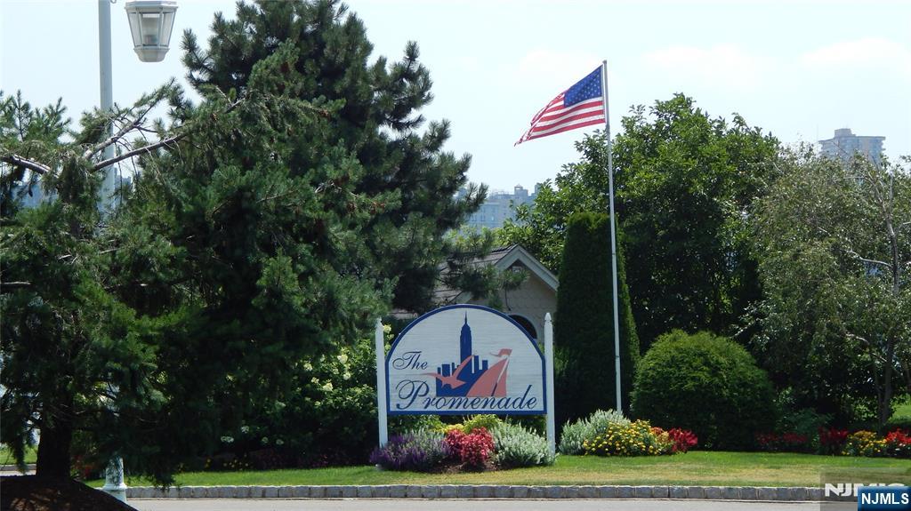 343 The Promenade, Unit 343 Edgewater, NJ 07020 - Photo 38 of 38 a flag is sitting in the middle of a park