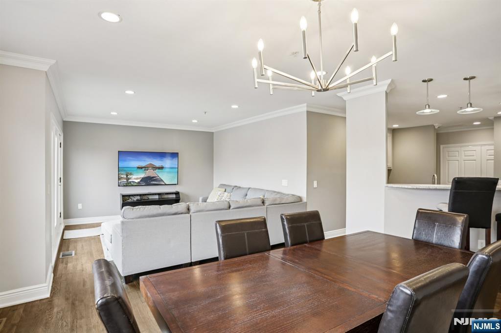 343 The Promenade, Unit 343 Edgewater, NJ 07020 - Photo 5 of 38 a living room with stainless steel appliances furniture a dining table and chairs