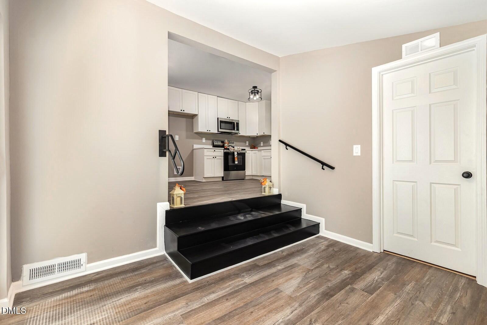 3204 Friar Tuck Road Raleigh, NC 27610 - Photo 12 of 26 a view of entryway and hall with wooden floor