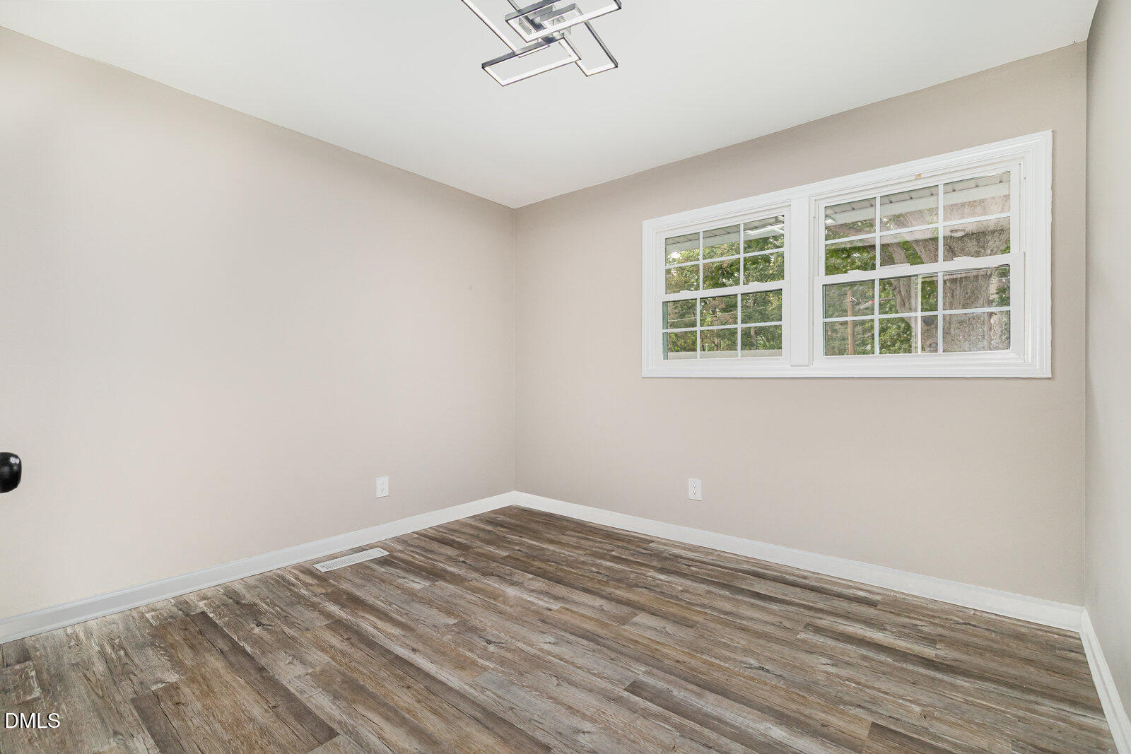 3204 Friar Tuck Road Raleigh, NC 27610 - Photo 15 of 26 a view of empty room with wooden floor and windows