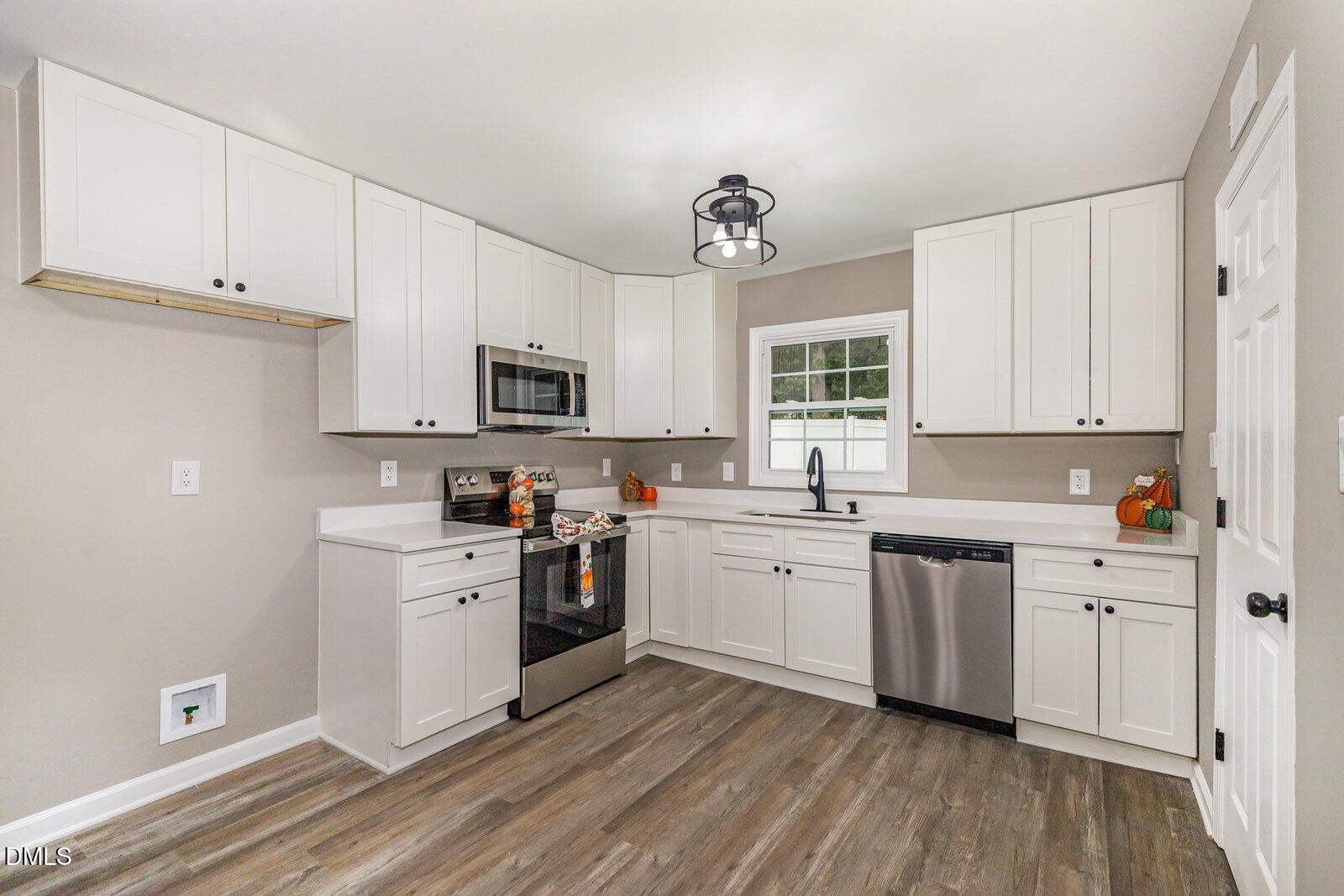 3204 Friar Tuck Road Raleigh, NC 27610 - Photo 9 of 26 a kitchen with granite countertop white cabinets and white appliances