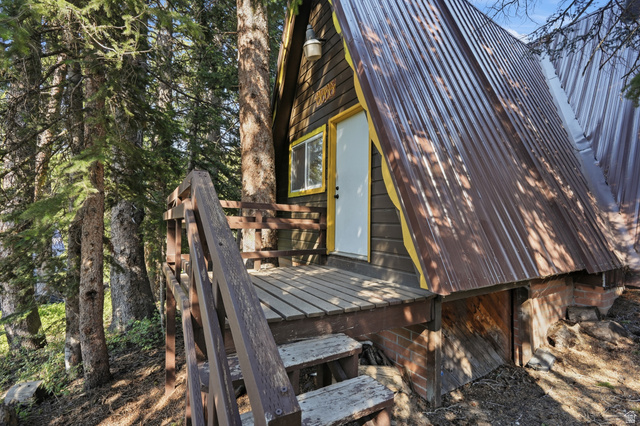 8505 South Snake Crk Road Salt Lake City, UT 84121 - Photo 46 of 67 A-frame structure featuring wood siding and a corrugated metal roof