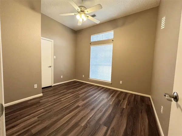 a view of a room with a ceiling fan
