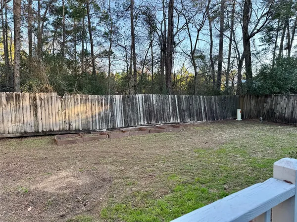 a front view of a house with glass windows and plants