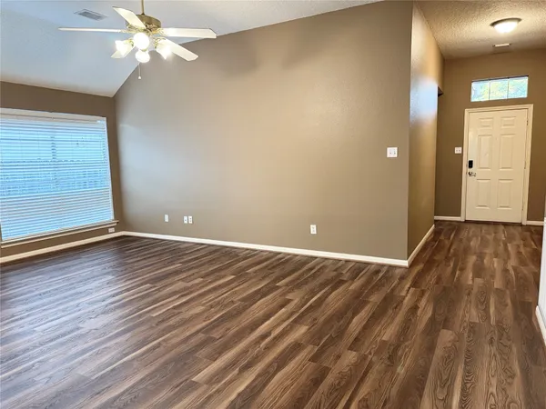 wooden floor in an empty room with a window