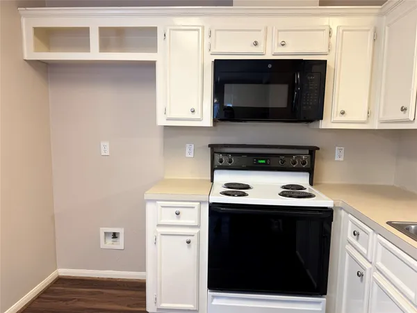 a kitchen with stainless steel appliances a stove a microwave and cabinets