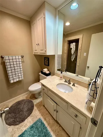 a bathroom with a sink a toilet and mirror
