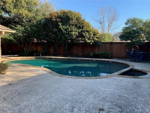 a view of a swimming pool with a yard