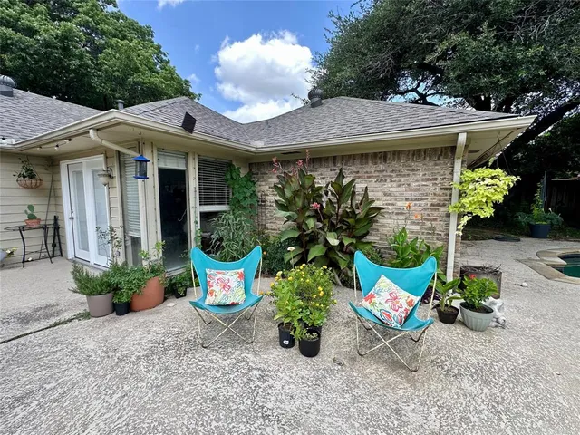 a view of a patio with furniture and potted plants