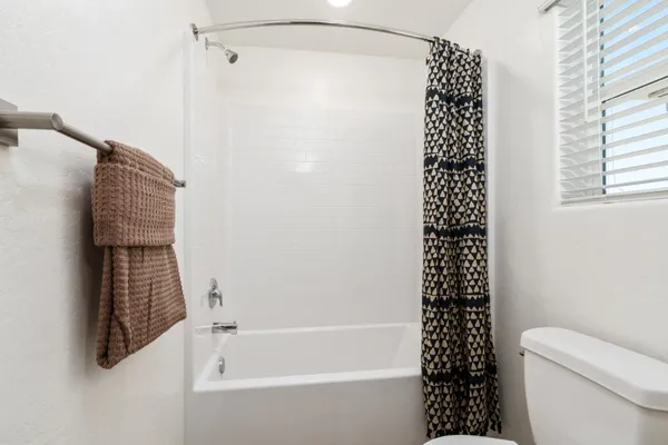 a bathroom with a bathtub and shower