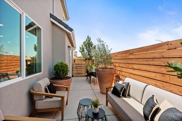 a view of a patio with couches chairs and potted plants
