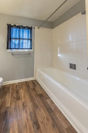 a bathroom with a bathtub and shower