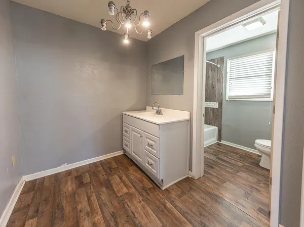 a bathroom with a sink a mirror and a light fixture