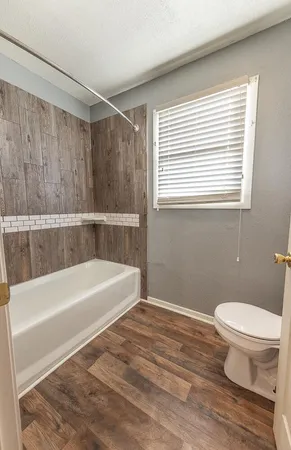 a bathroom with a bathtub and a toilet