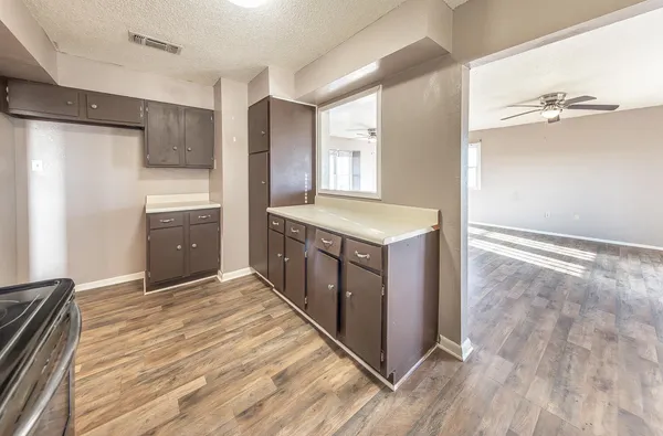 a kitchen with stainless steel appliances granite countertop a sink and a refrigerator