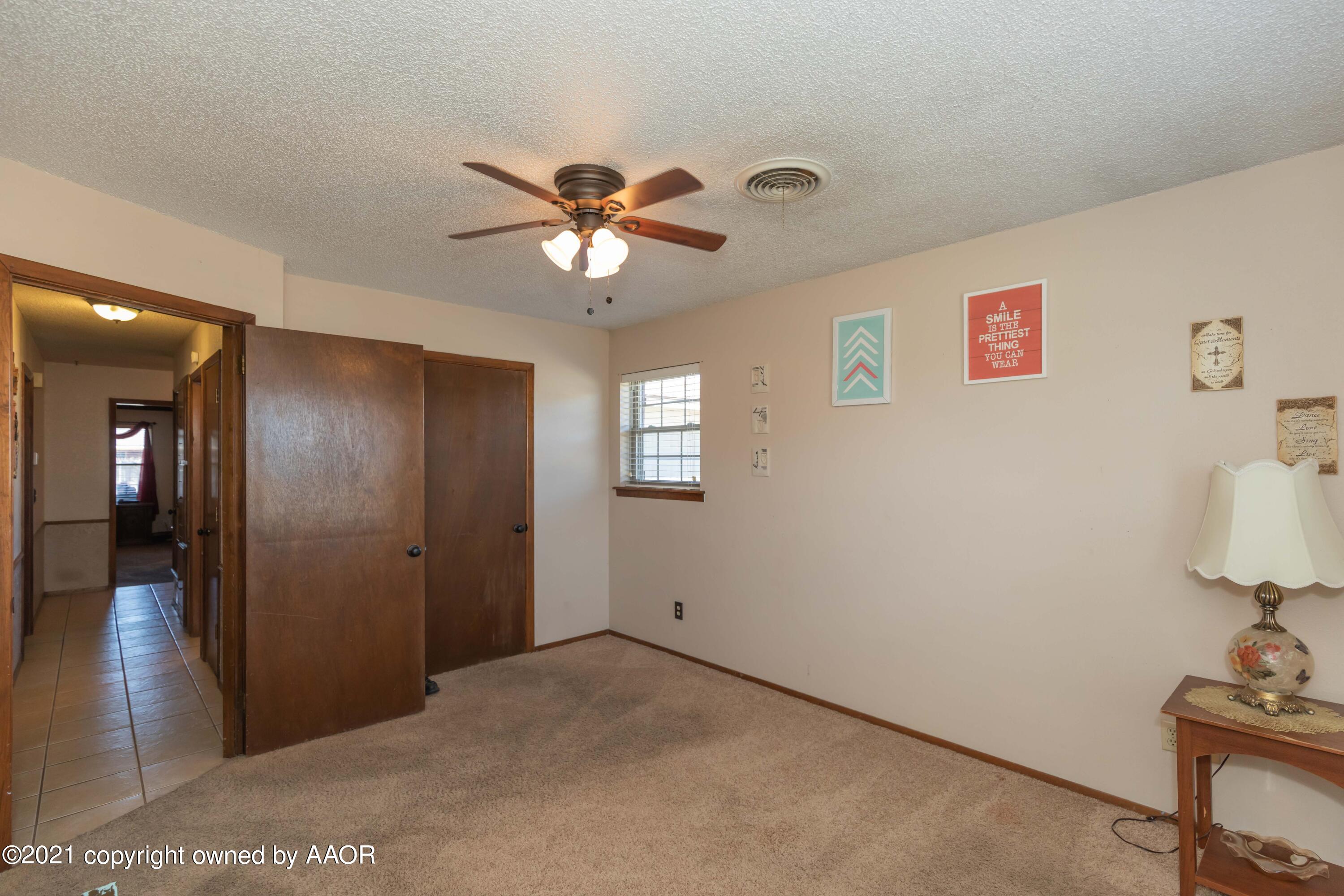 8100 Santa Fe Trail Amarillo, TX 79110 - Photo 29 of 35 a view of a livingroom with a chandelier fan and wooden floor