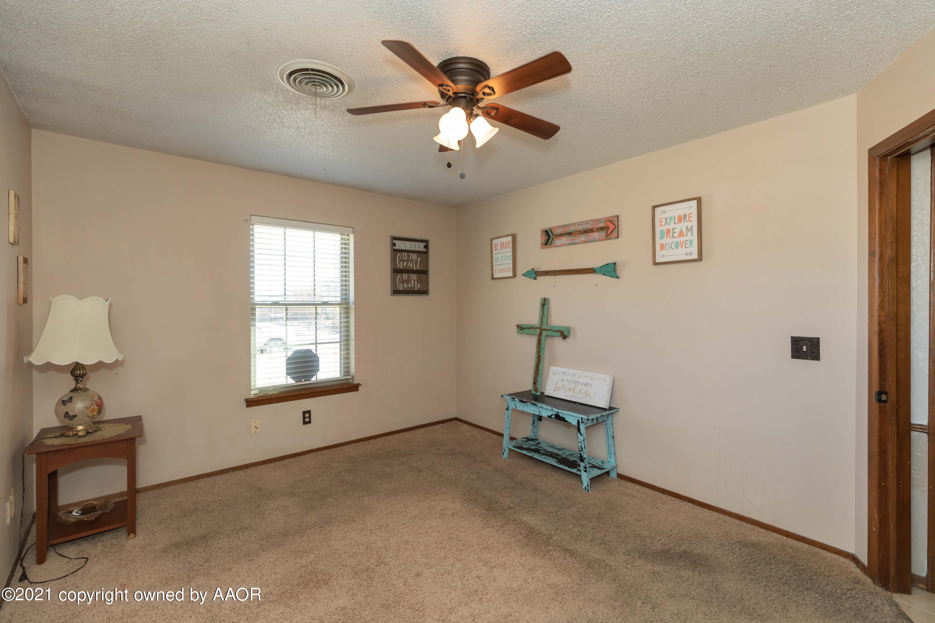 8100 Santa Fe Trail Amarillo, TX 79110 - Photo 31 of 35 a room with chandelier fan and windows