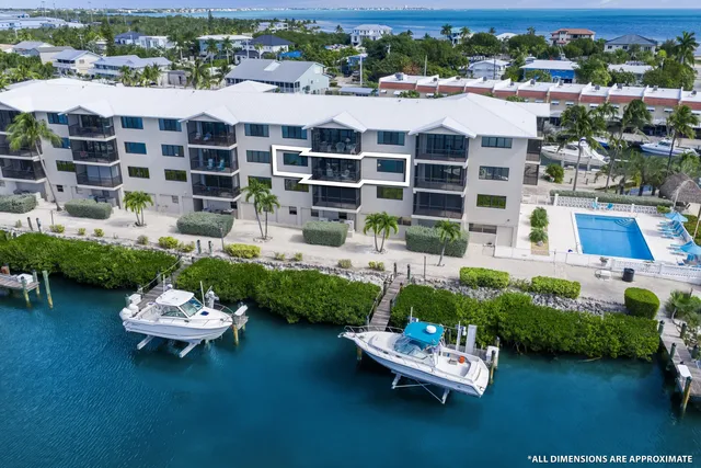 a front view of a house with a garden and patio