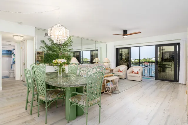 a view of a dining room with furniture wooden floor and chandelier