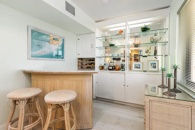 a view of a dining room with furniture and a potted plant