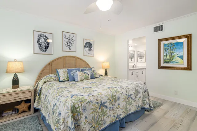 a bedroom with a bed and a painting on the wall