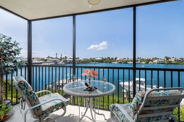 a view of a chairs and table on the roof deck