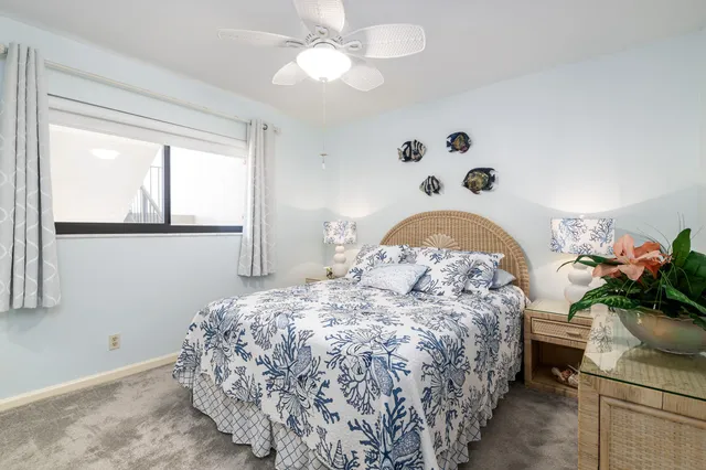 a bedroom with a bed and a potted plant