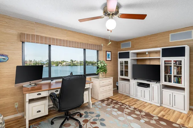 a view of a livingroom with workspace and a window