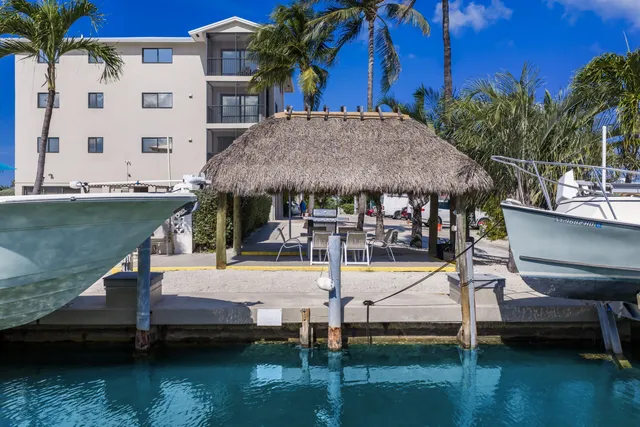a view of a patio with table and chairs potted plants