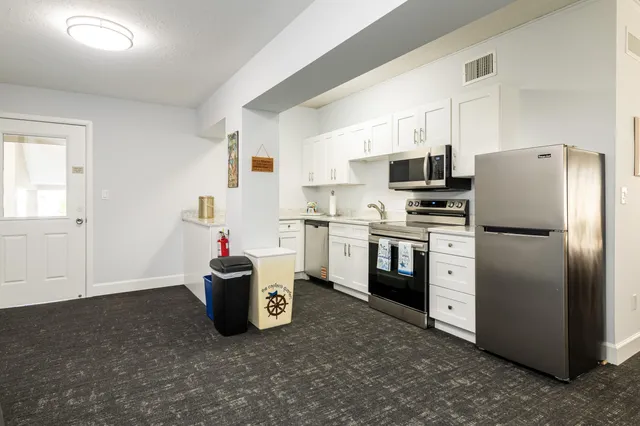 a view of a dining room with furniture and window