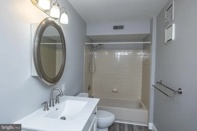a bathroom with a toilet sink and shower