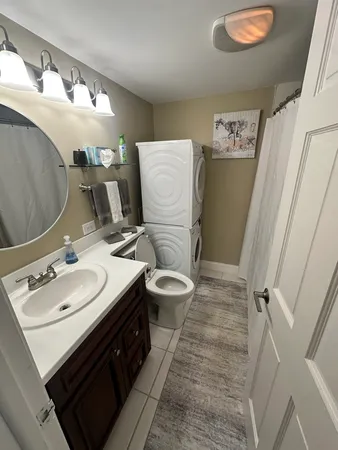 a bathroom with a double vanity sink mirror and toilet