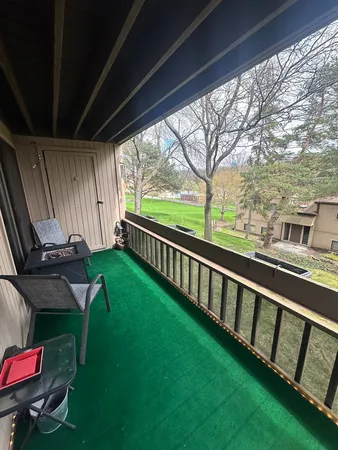 a view of a chairs in backyard of house