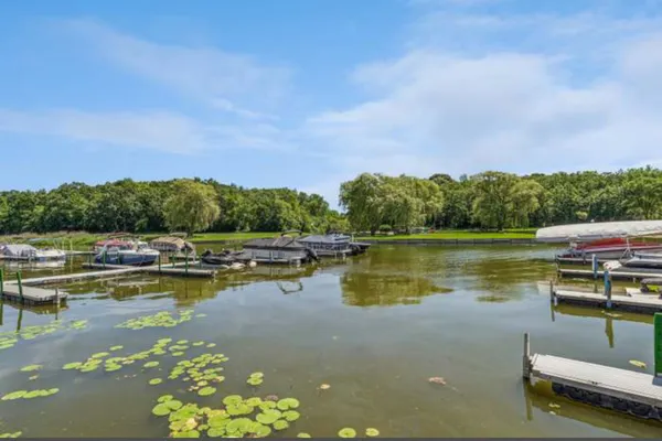 a view of a lake with houses in the back