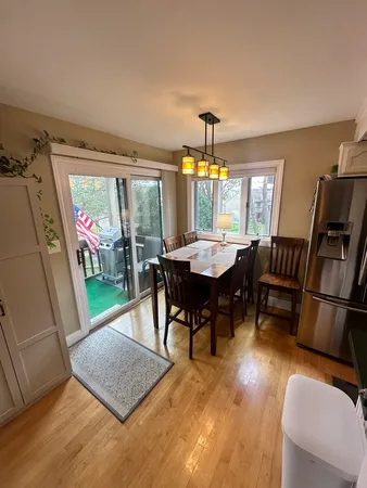 a view of a dining room with furniture window and wooden floor