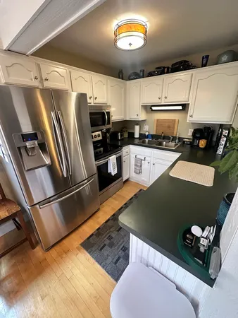 a kitchen with stainless steel appliances granite countertop a refrigerator sink and stove