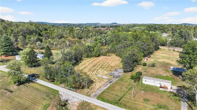 an aerial view of a residential houses with outdoor space