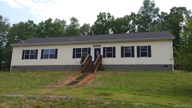 a house that has a big yard in front of it