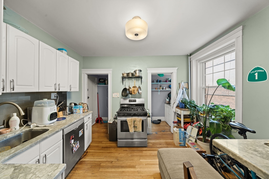 224 Jamaicaway, Unit 5 Boston, MA 02130 - Photo 4 of 15 a kitchen with stainless steel appliances a stove a sink and a refrigerator