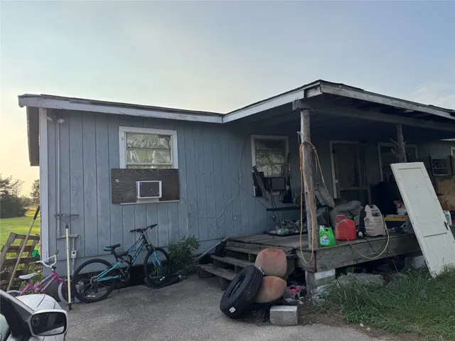 a view of a green field with trees