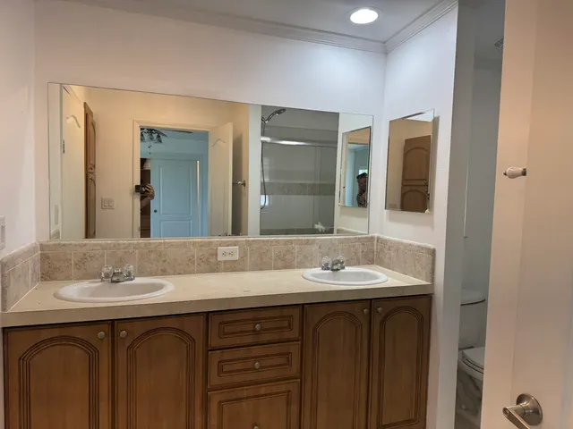a bathroom with a double vanity sink and a mirror