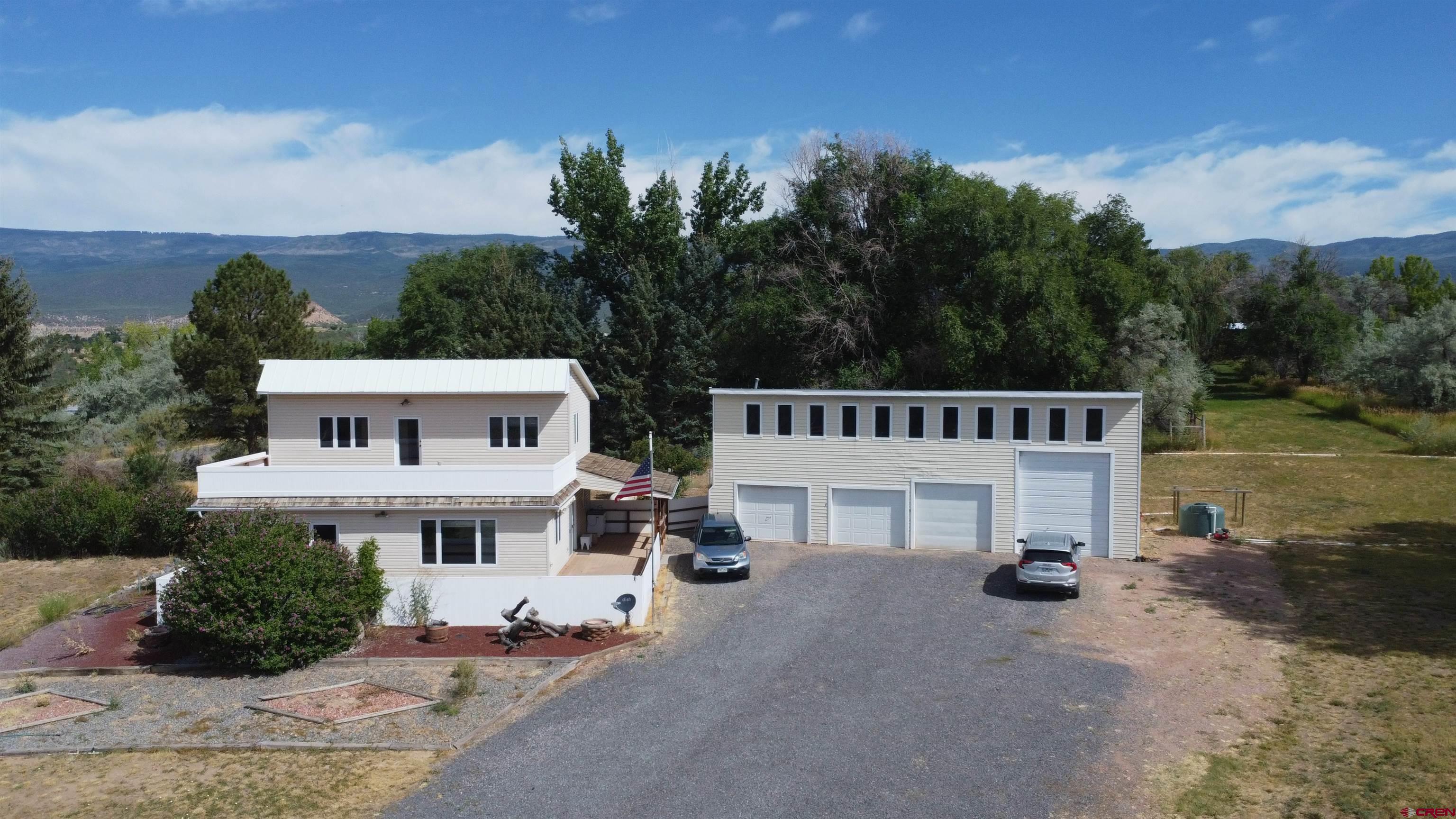 16754 Bull Mesa Road Cedaredge, CO 81413 - Photo 1 of 35 an aerial view of a house with a garden and deck