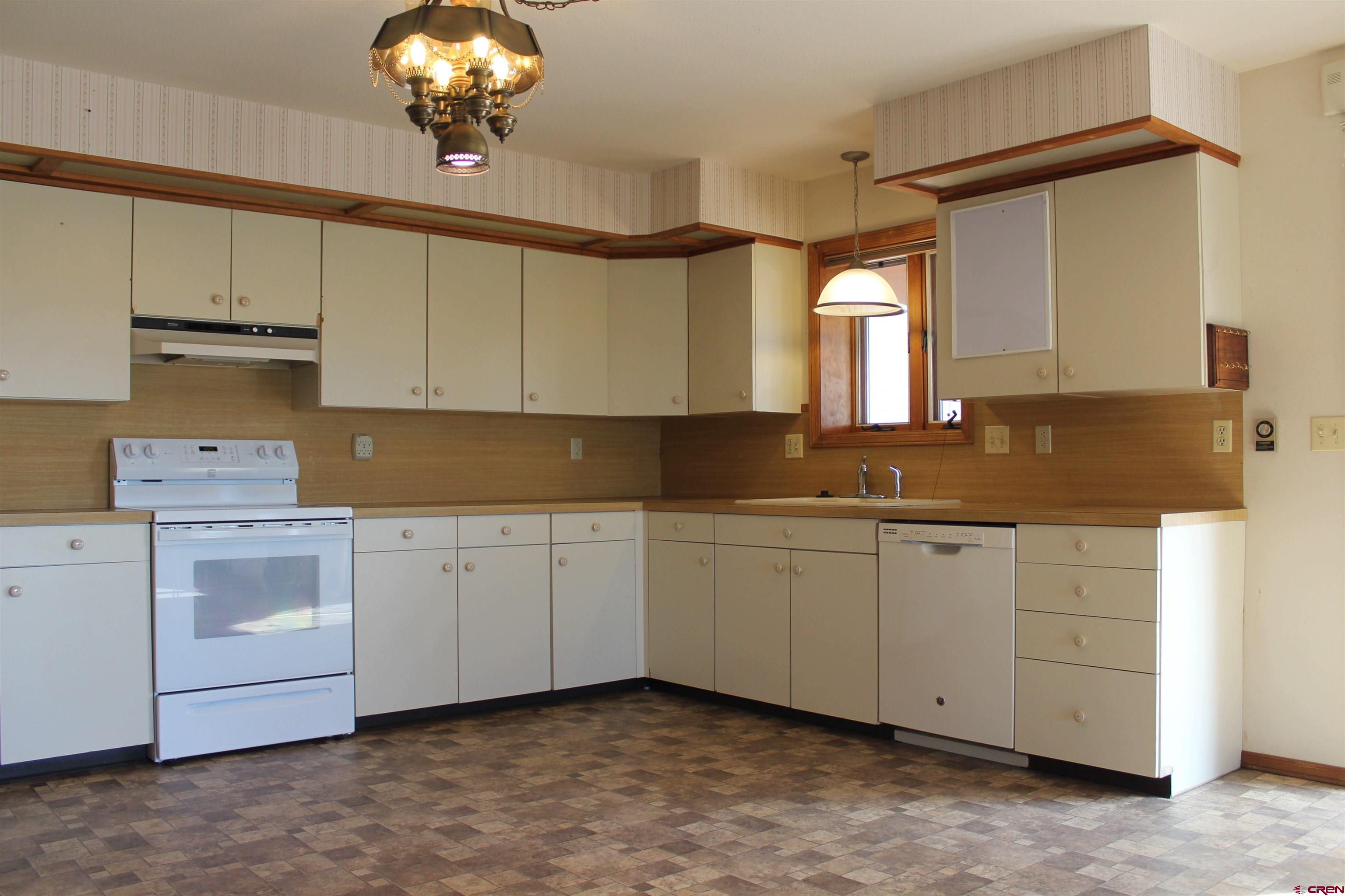 16754 Bull Mesa Road Cedaredge, CO 81413 - Photo 12 of 35 a kitchen with granite countertop a sink and cabinets