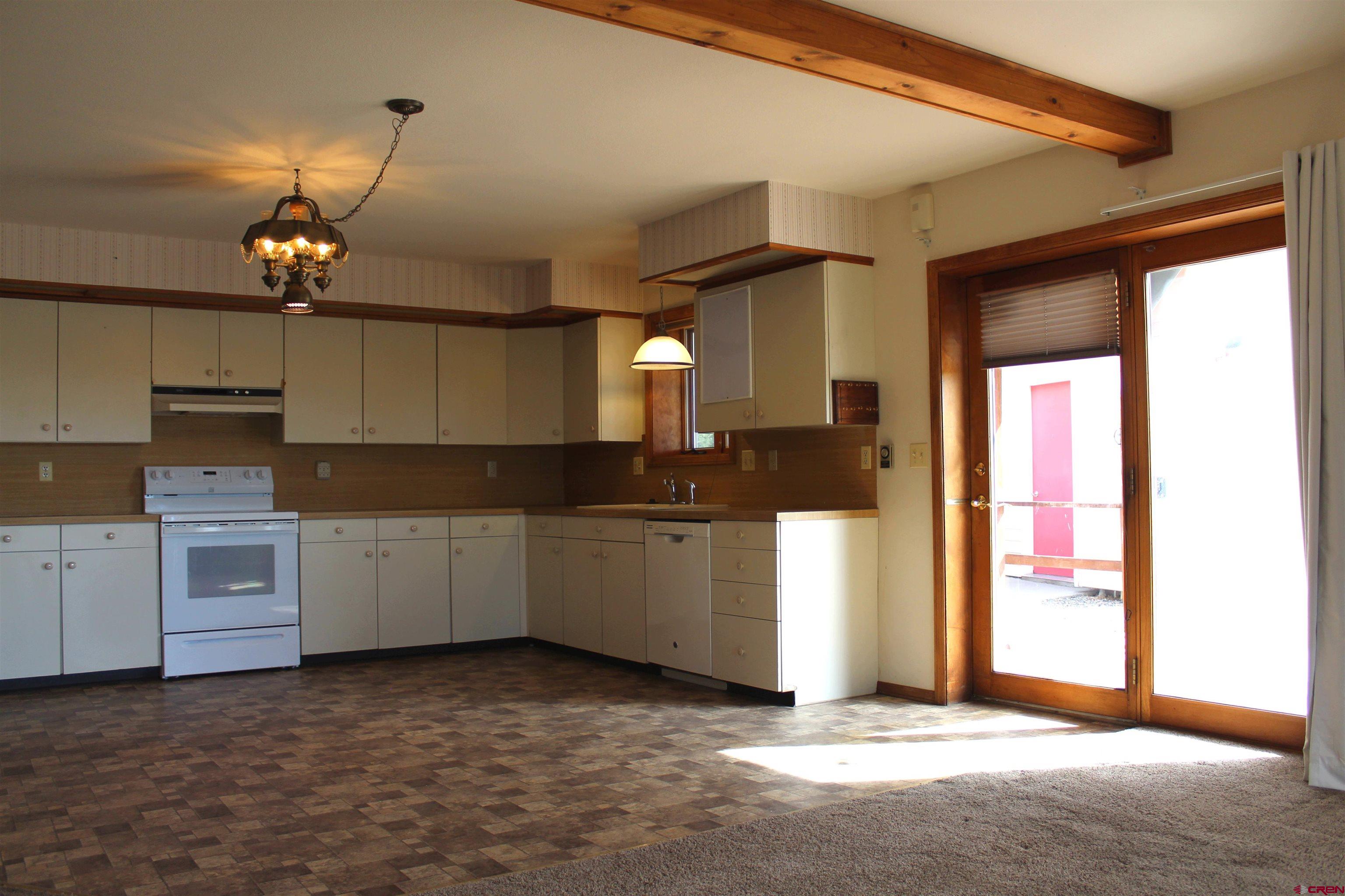 16754 Bull Mesa Road Cedaredge, CO 81413 - Photo 14 of 35 a kitchen with a refrigerator and stove