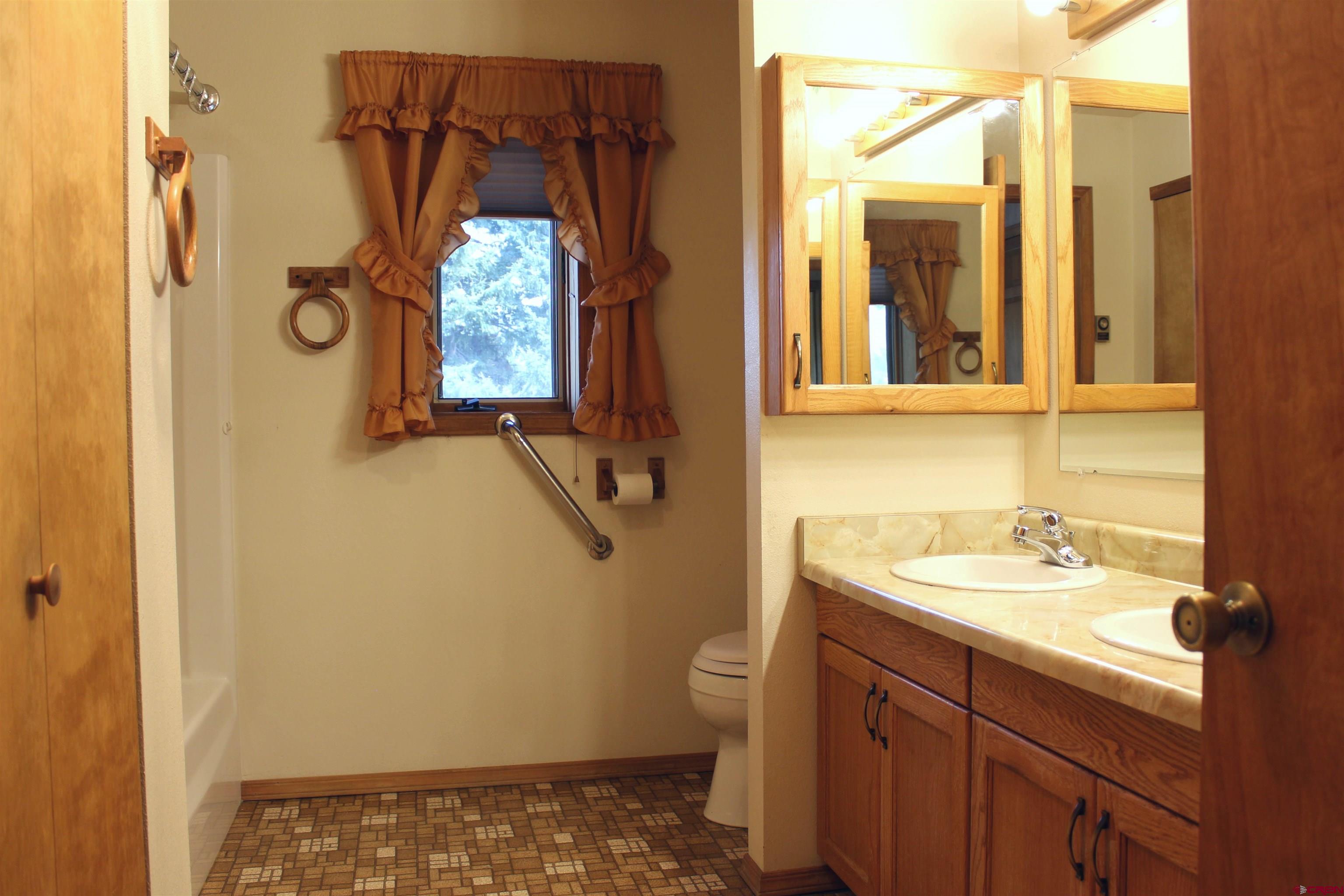 16754 Bull Mesa Road Cedaredge, CO 81413 - Photo 18 of 35 a bathroom with a sink and a mirror