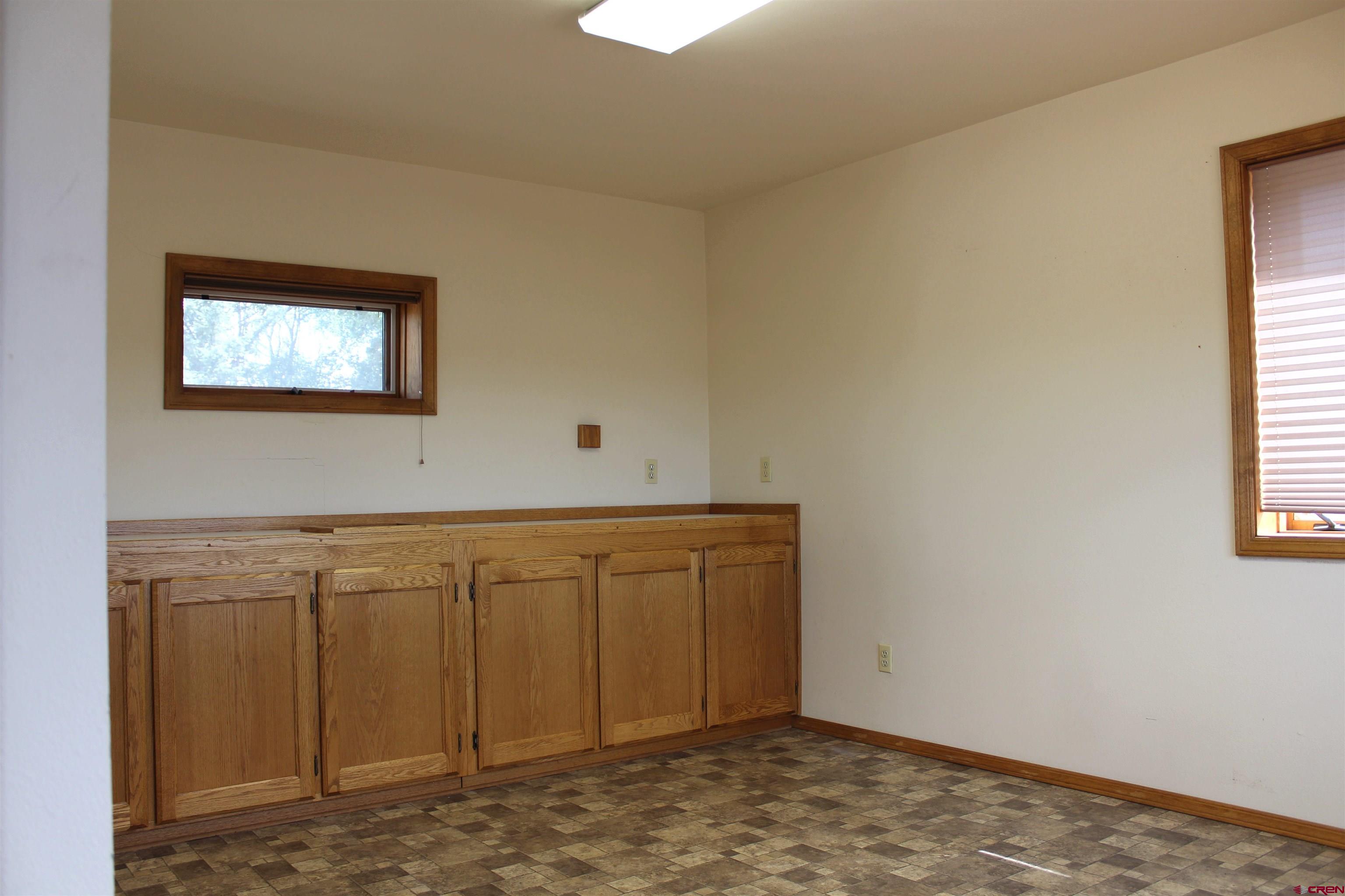 16754 Bull Mesa Road Cedaredge, CO 81413 - Photo 20 of 35 a view of an empty room with window