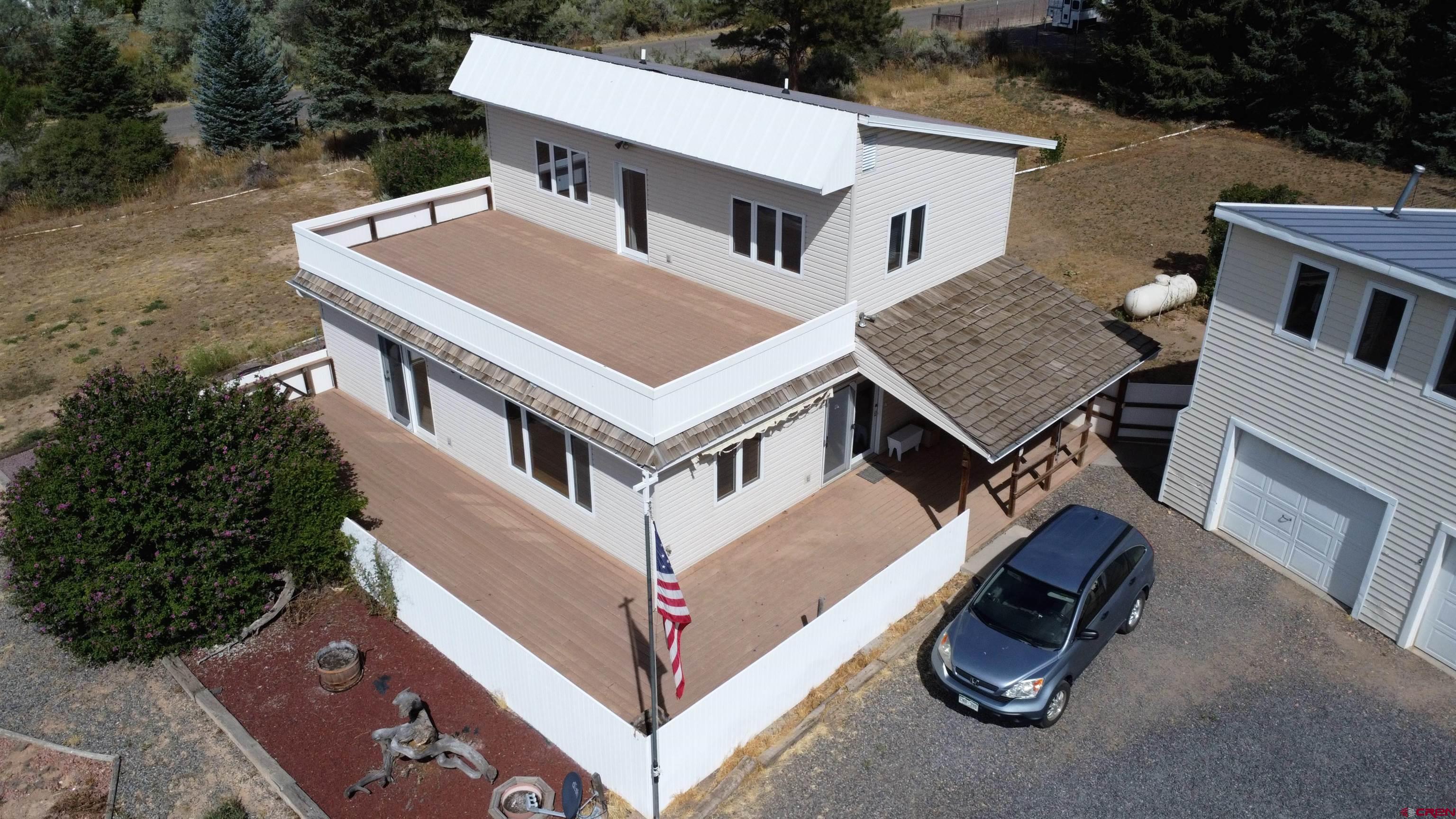 16754 Bull Mesa Road Cedaredge, CO 81413 - Photo 2 of 35 an aerial view of a house with roof deck