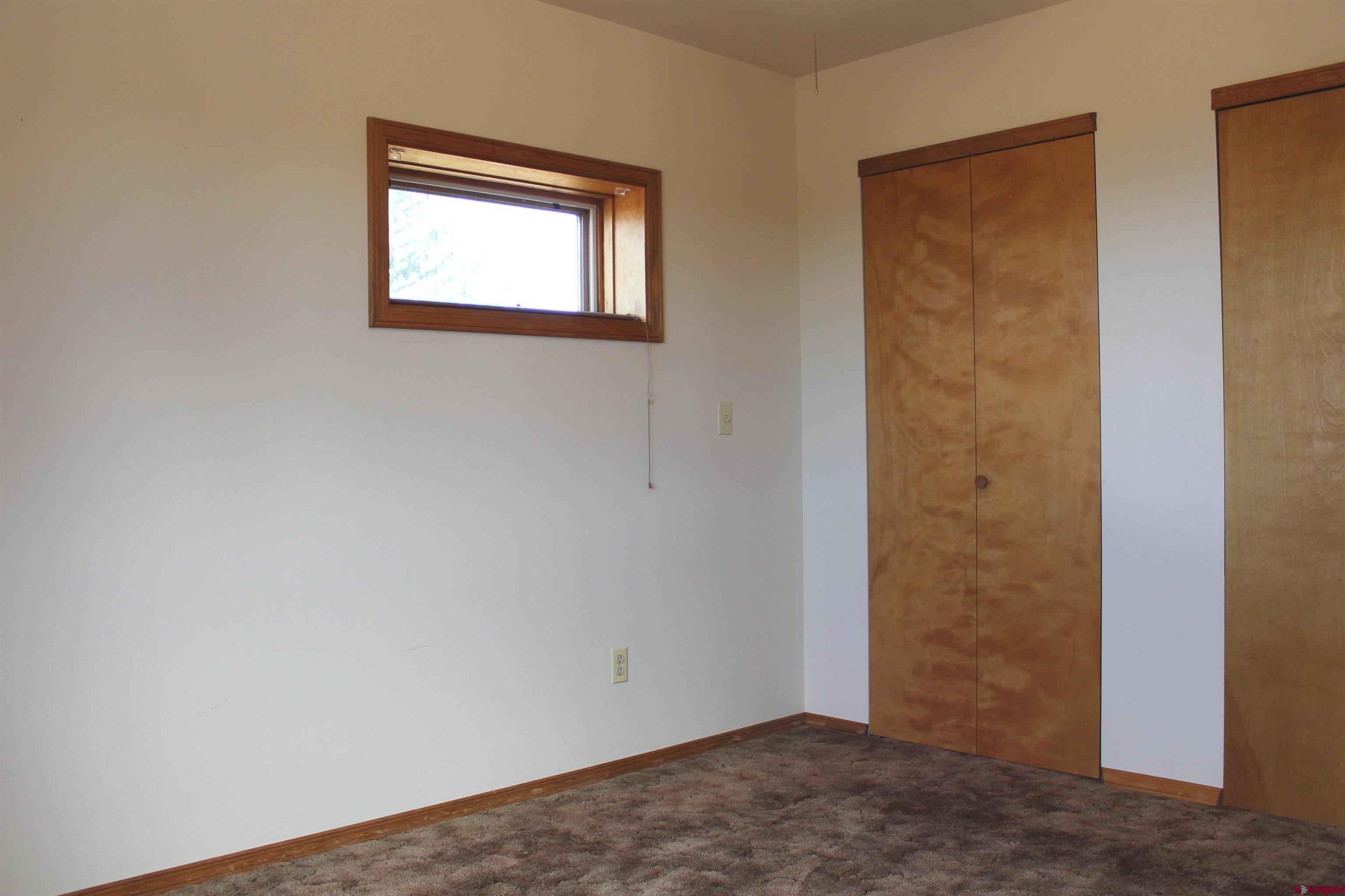 16754 Bull Mesa Road Cedaredge, CO 81413 - Photo 21 of 35 an empty room with windows